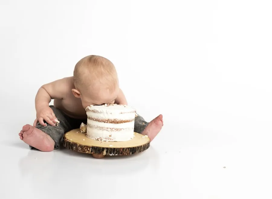 A baby diving face-first into his first birthday cake